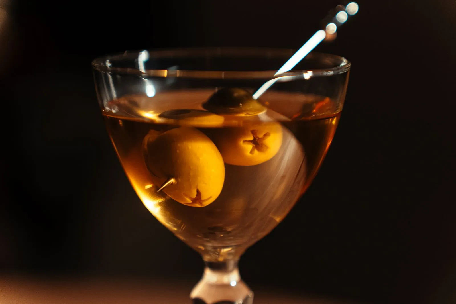 A close-up of a classic martini with olives, beautifully presented in a Tokyo cocktail bar.